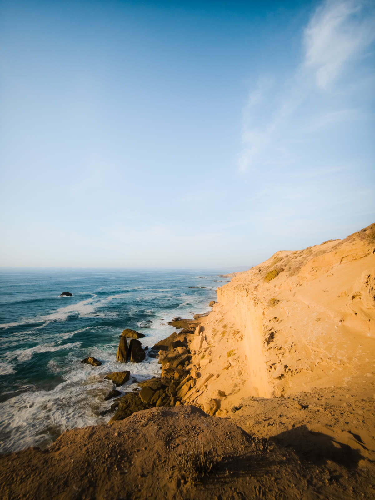 Golden dune cliff above the ocean