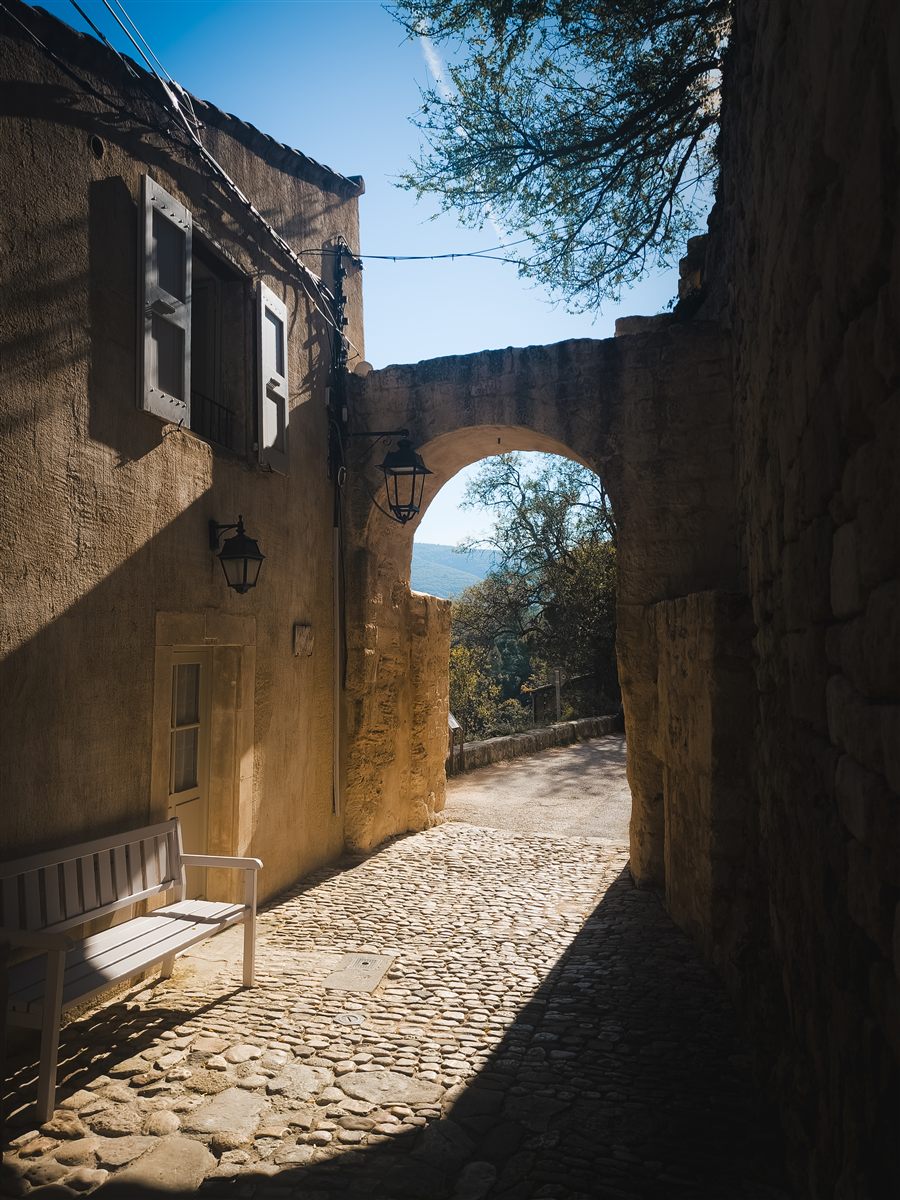 Village lane under a stone arch