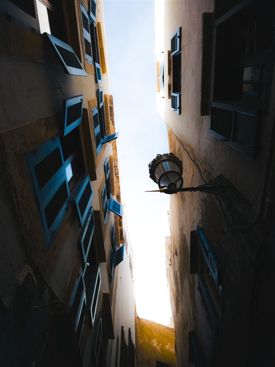 Blue shutters in a narrow medina street