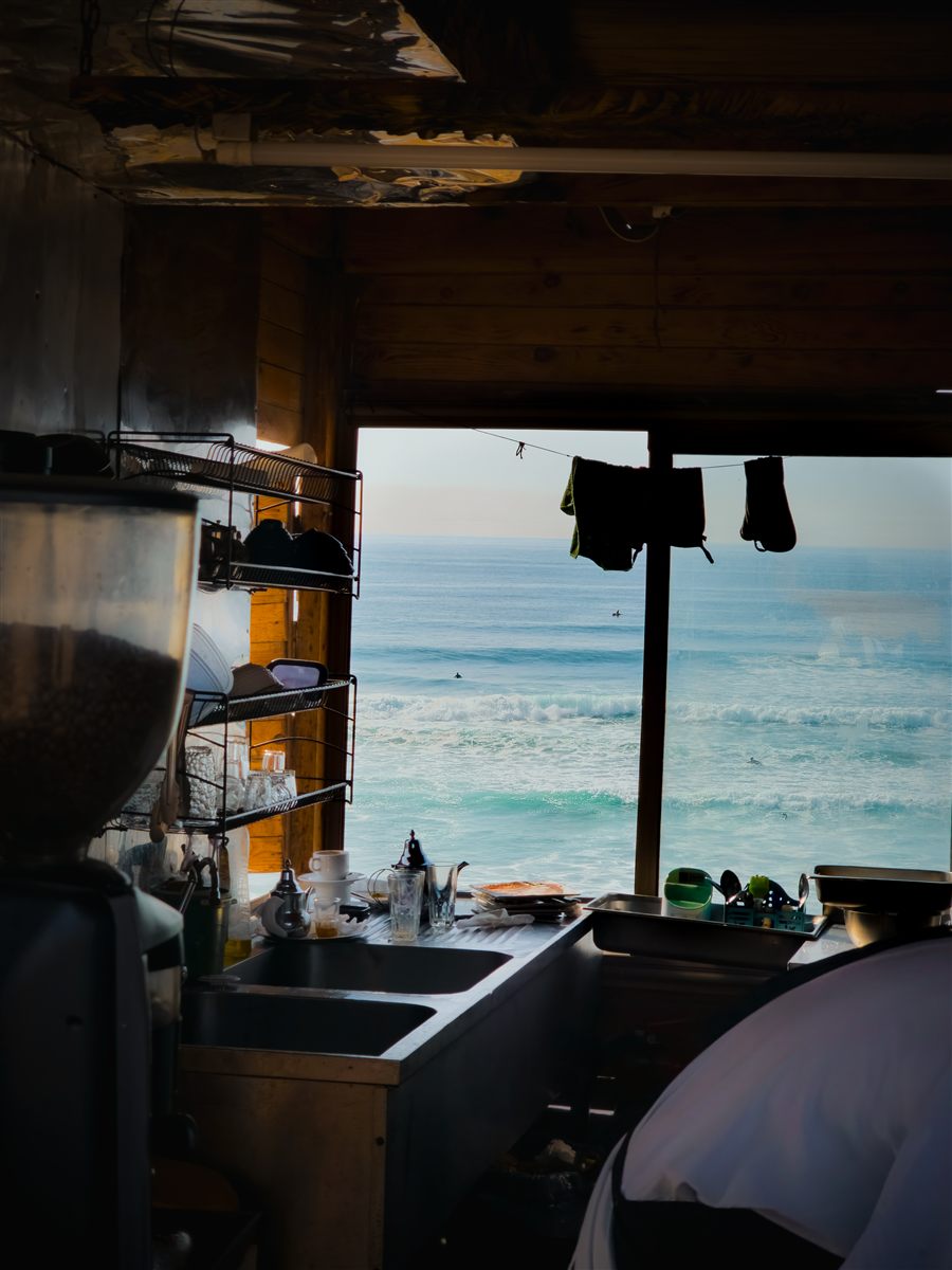 Ocean waves seen through a beach cafe kitchen window