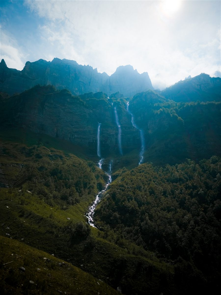Waterfalls running down a green valley